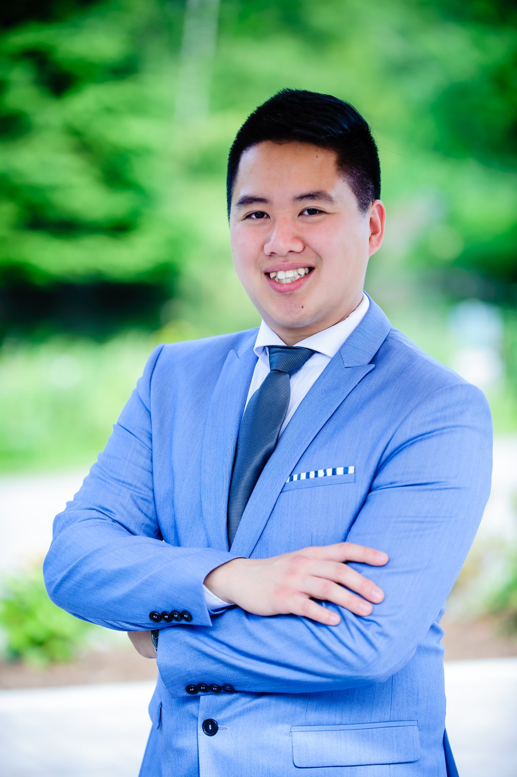Clement Chung outdoors, wearing a blue suit